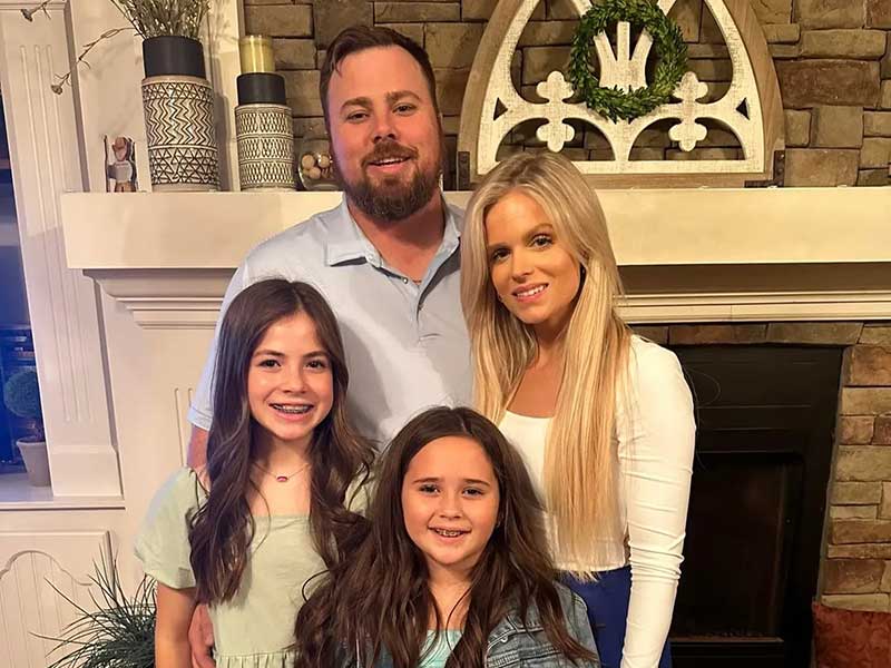 Owner Brandon Powers posing for a photo with his wife and two daughters