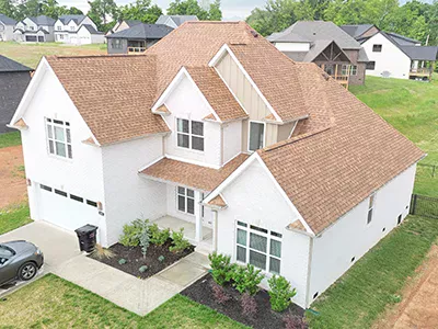 Mid-class home with new sand-colored shingles