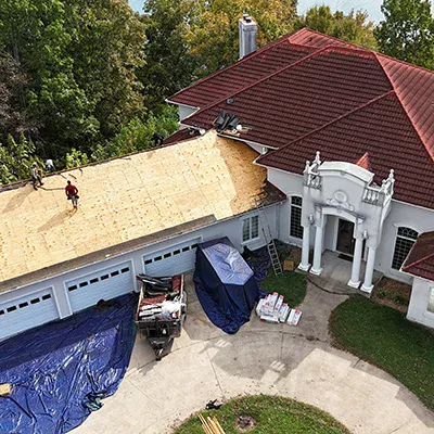 Crew replacing roof on high-end home